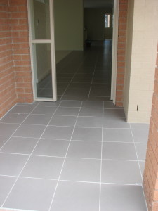 A grey tiled porch leads seamlessly into the home without any change in level.