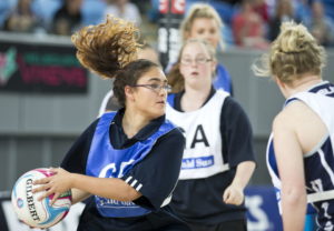 Picture of young women on a netball court.