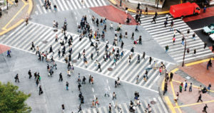 Birds eye view of a wide pedestrian crossing with lots of people on it