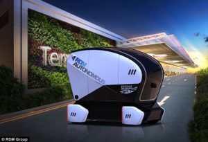 A small black and white pod shaped automated driverless vehicle.