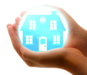 a blue glowing house icon is held in the hands