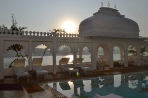 Indian hotel swimming pool at sunset.