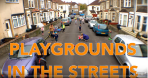 A suburban street in Bristol with cars parked on both sides of the road. Children are playing in the street.