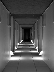 hallway with lighting across the floor making it look like steps