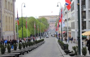long view down a cobbled street to the Norwegian palace building