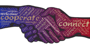 Graphic of a handshake with purple hands. The hands have words on them such as cooperate and connect