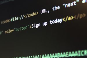 part of a computer screen with black background and some words indicating coding.