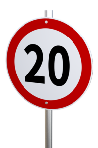 A red and white circular sign with a 20 speed limit showing. Drivers can't see invisible disability. 