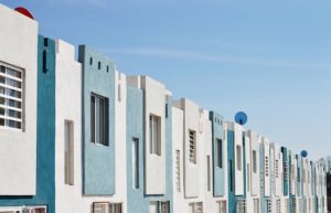 A row of flat front row homes in blue and white. Downsizing? But where to?