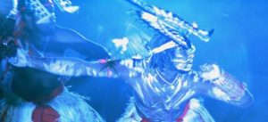 A blue picture with swirling shapes as if under water.