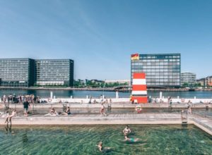 A sunny day in Copenhagen brings out the swimmers at the outdoor baths that are edged with timber boardwalks.
