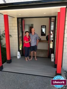 Max and Tricia stand at their doorway which reflects their love of Japanese design.