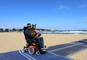 A wheelchair user has access to the beach with the Council beach mat. Standards for tourism.
