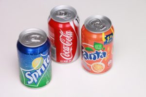Three soda cans showing the ring pull opener. Older adults lead universal design.