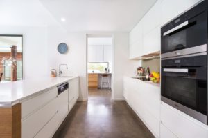 A spacious kitchen with white cabinetry. Is cost the real issue?