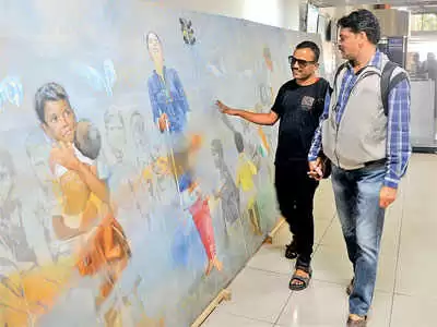 Two men are standing next to a painting. One man has his hands on the painting. Braille and tactile paintings.