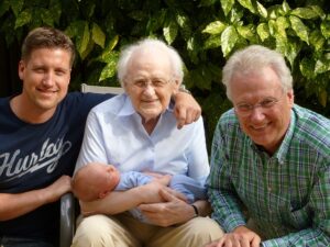 Four generations. A baby, father, grandfather and great-grandfather. Multigenerational. 