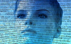 Rows of computer code are laid over the face of a woman. representing accessible software.