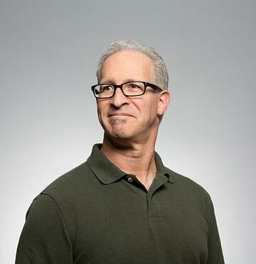 A middle aged white man wearing glasses