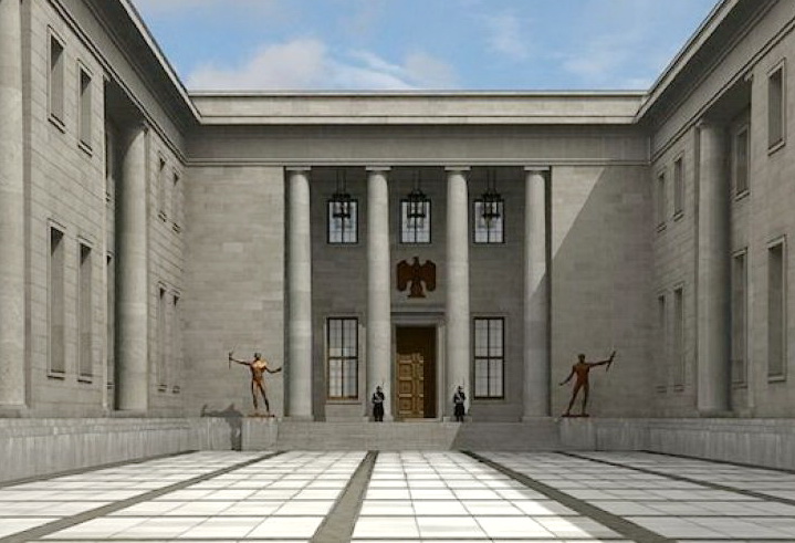 A tall imposing grey concrete building with four giant columns and a bronze statue to either side of the giant doorway.