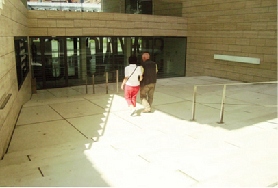 Entry to the museum where the sunlight makes the steps look like a flat white plane even to people with good vision.