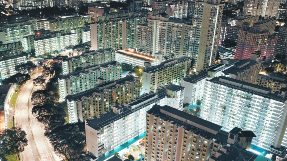 An aerial view of a densely populated area with rows of high rise tower blocks